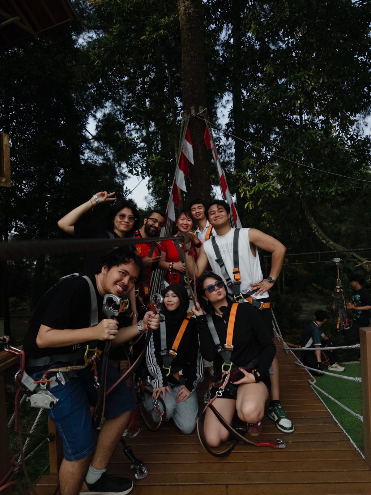 The group in harnesses on the wooden suspension bridge